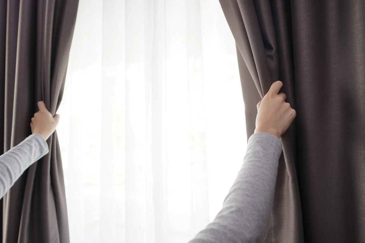 closeup women hand opening curtain