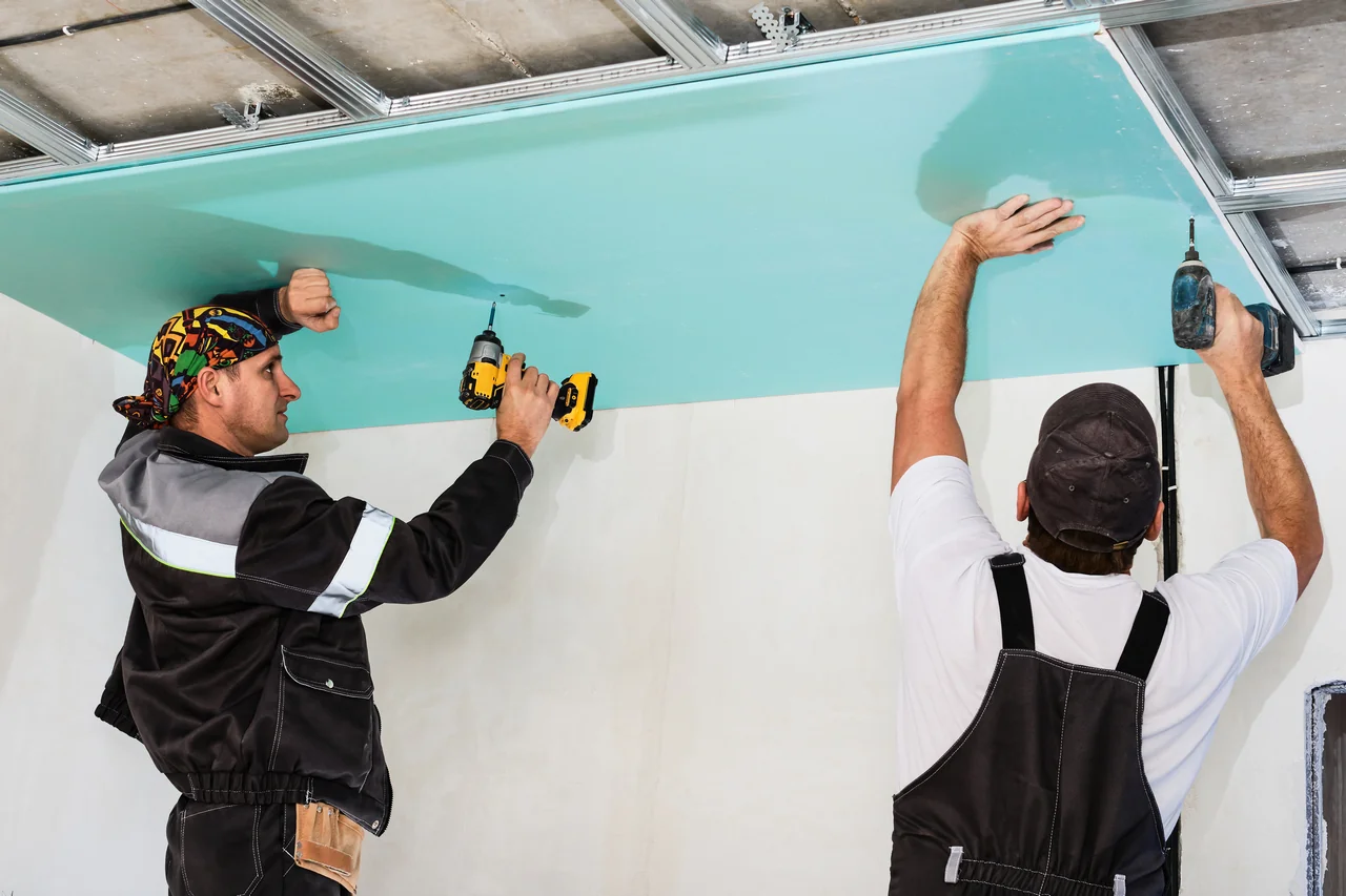 plasterboard installers men assembling drywall false ceiling simple affordable renovation premises