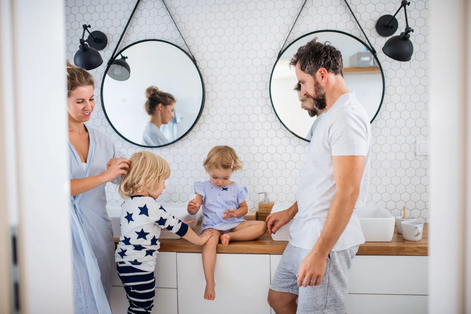 young family with two small children indoors in bathroom