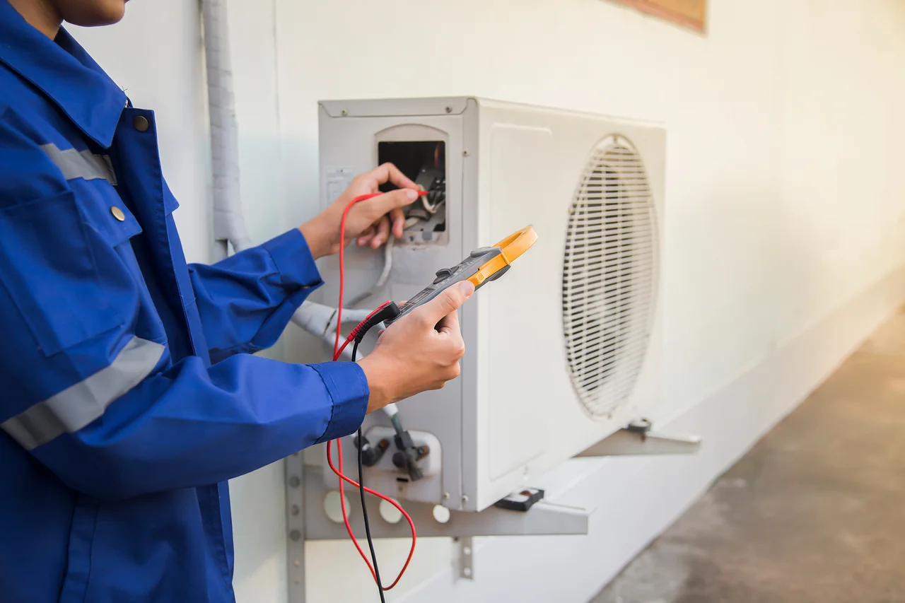 technician checking operation air conditioner
